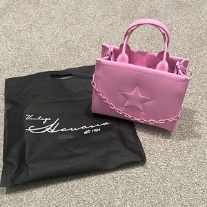 The Alyce Bag Features: 

Top Handle
Adjustable Crossbody strap
Star detail